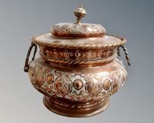 An antique copper twin handled lidded pot.