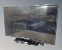 A Hitachi 32" LCD Smart TV with remote.
