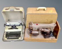 A 20th century Singer electric sewing machine, together with a vintage Olympia typewriter in case.