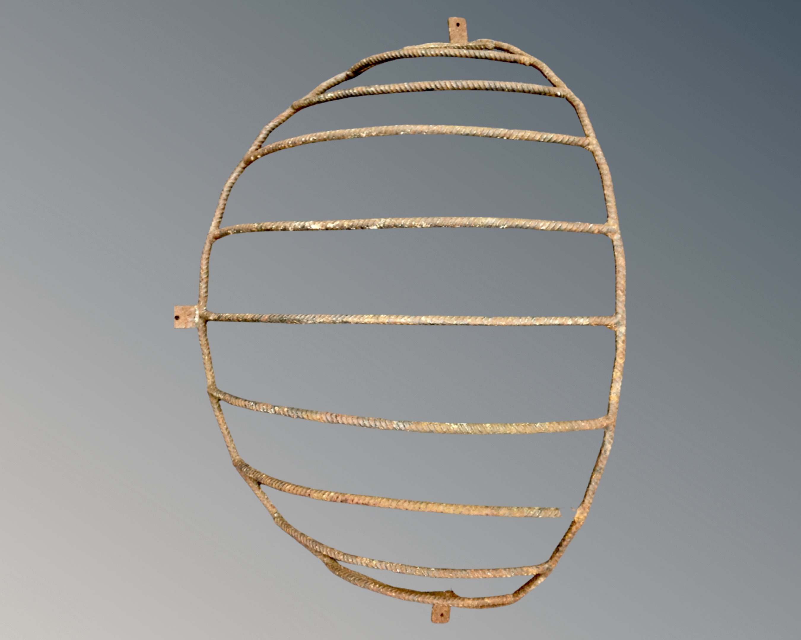 A vintage cast iron wall mounted hay rack.