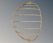 A vintage cast iron wall mounted hay rack.