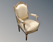 A Baroque cream and gilt armchair.
