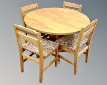 A circular pedestal kitchen table together with four chairs.
