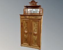 A 19th century Biedermeier mahogany and walnut double door cabinet fitted with two drawers and a