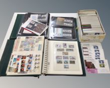 A box of three albums in slip covers of first day covers together with a further box of a large