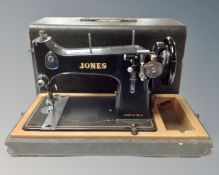 A vintage Jones hand sewing machine in case.
