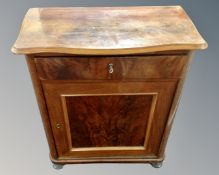 A 19th century mahogany shaped front cabinet fitted with a drawer.