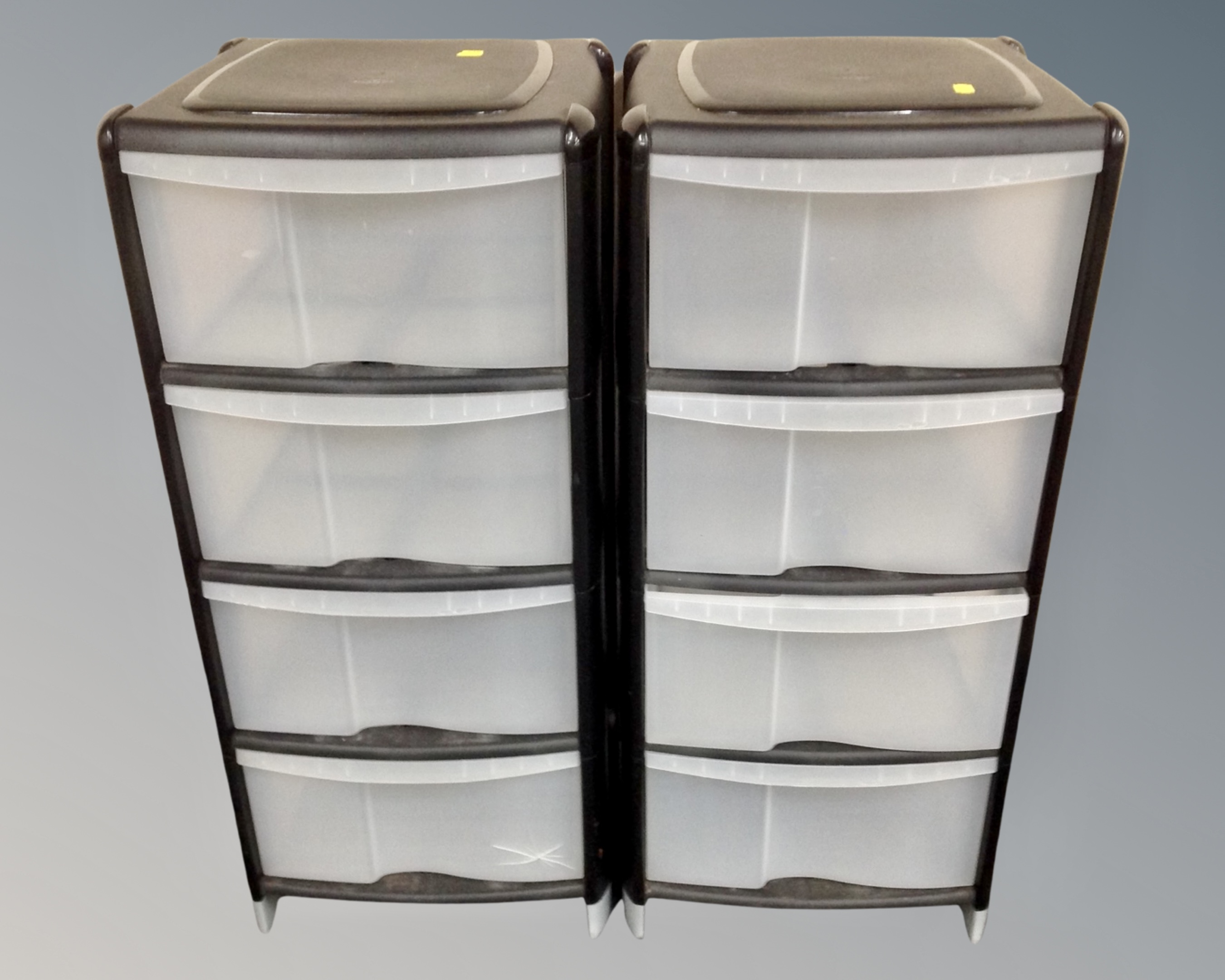 Two four drawer plastic storage chests.