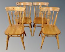 A set of four pine dining chairs.