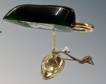 A vintage brass banker's desk lamp with green glass shade