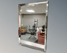 A contemporary all glass framed bevel edged mirror.