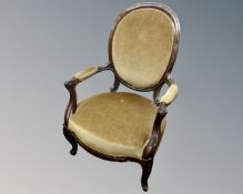 A 19th century beech wood framed open armchair upholstered in dralon.