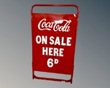 A folding metal A-frame bearing Coca-Cola on sale here 6d advertisement.
