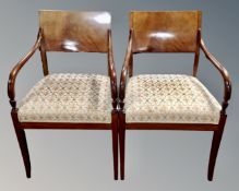 A pair of antique mahogany panelback carver armchairs.
