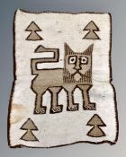 An eastern pictorial woollen rug depicting a stylised lion, 98cm by 75cm.