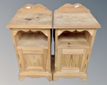 A pair of stripped pine bedside cabinets.