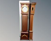 A Continental painted longcase clock with circular dial, pendulum and weights.