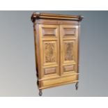 A Continental mahogany double door cabinet on raised legs.