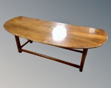 A mahogany flap sided D-end coffee table with brass mounts.