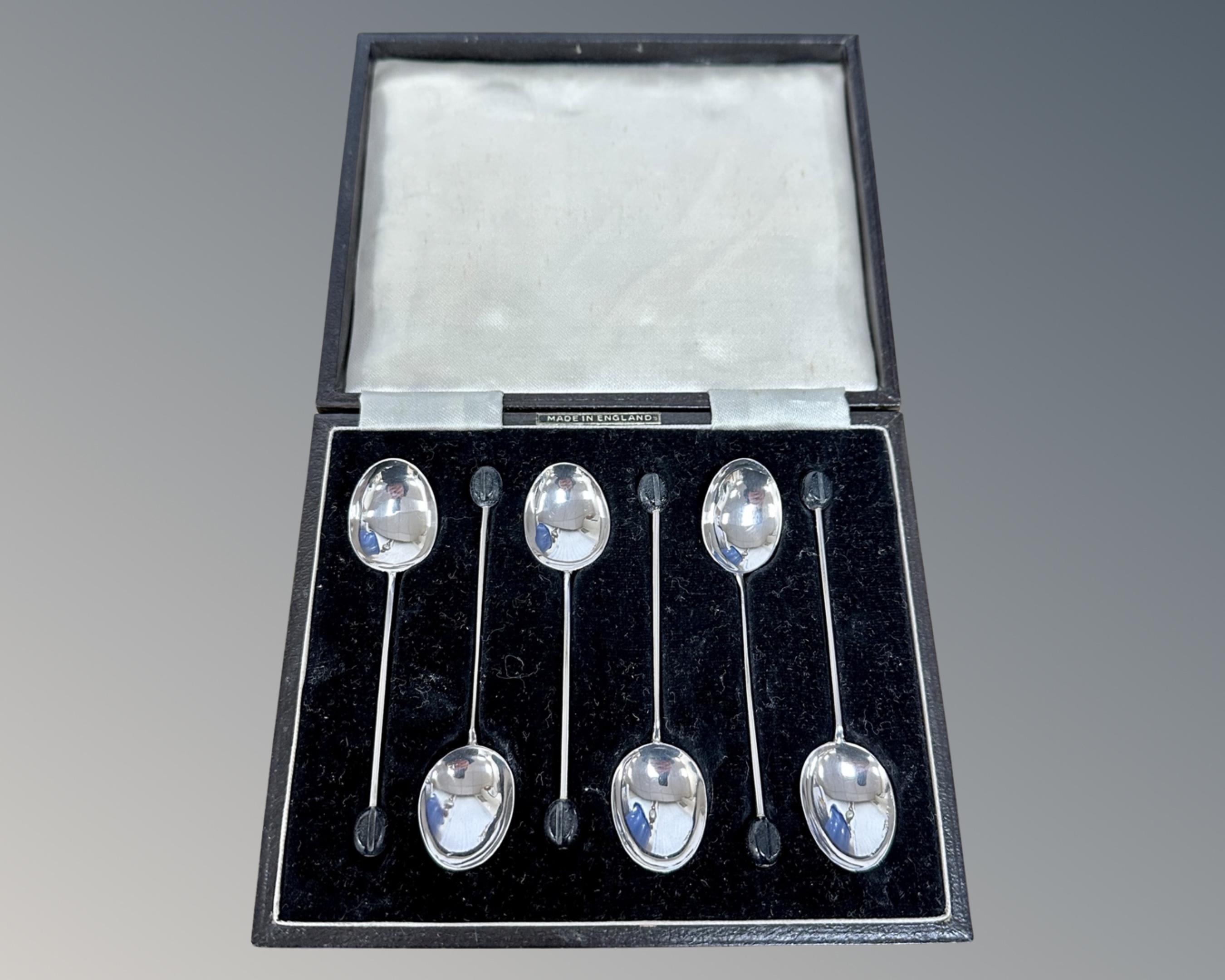 A set of six silver coffee spoons.