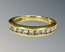 An 18ct gold diamond half eternity ring, size J½.