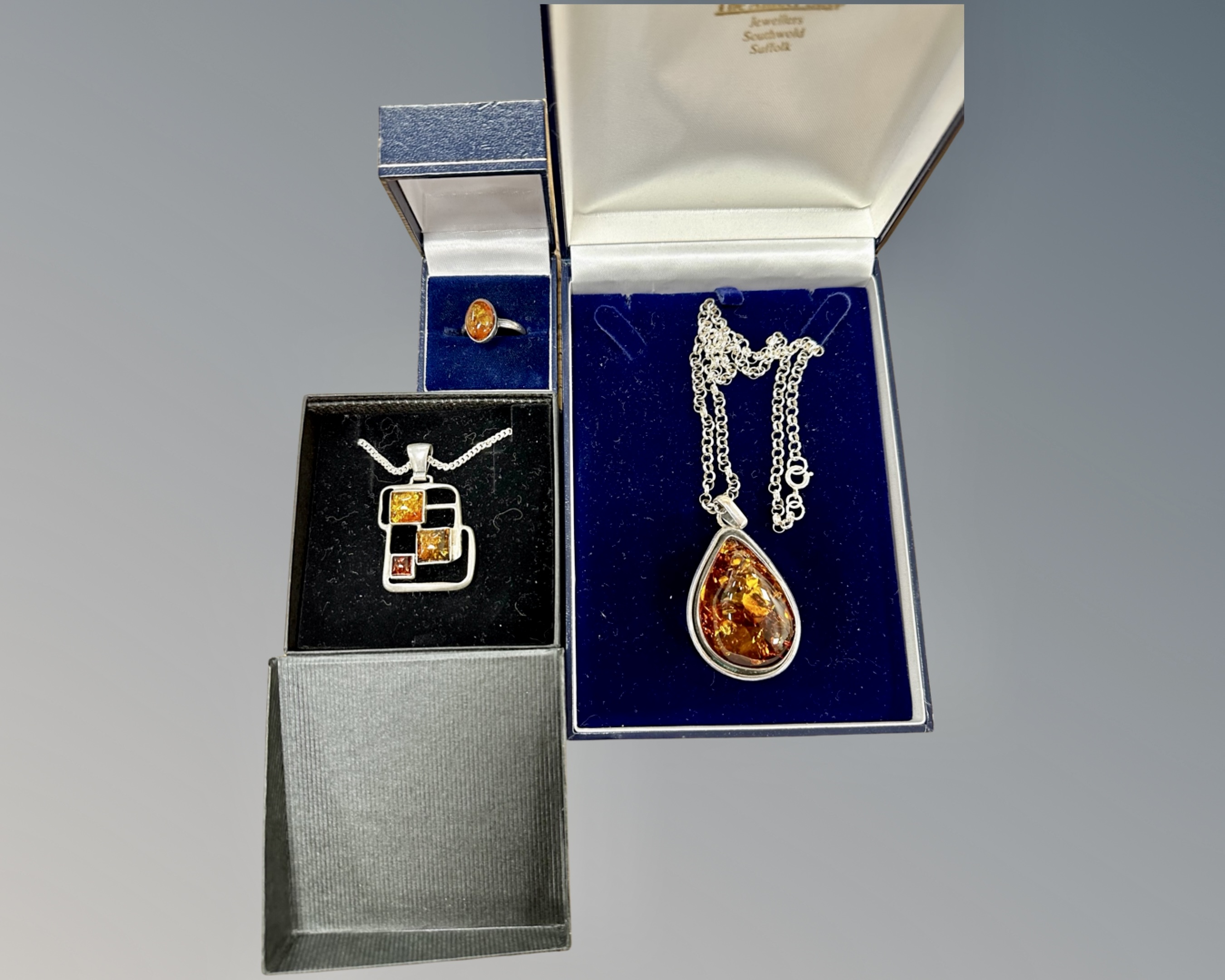 A Sterling silver mounted large amber pendant on chain,