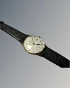 A 9ct yellow gold Garrard Automatic Gentleman's wrist watch on black leather strap,