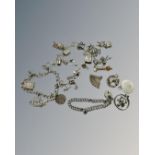 Two silver bracelets and a quantity of charms, 107g.