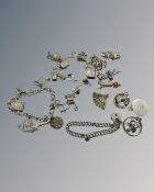 Two silver bracelets and a quantity of charms, 107g.