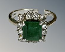 An 18ct white gold emerald and diamond ring, size N½.