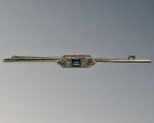 A 14ct white gold and platinum set diamond and sapphire bar brooch, width 65 mm, 3.7g.
