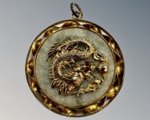 A 14ct yellow gold mounted double sided Chinese jade pendant, diameter 4 cm, gross weight 15.9g.