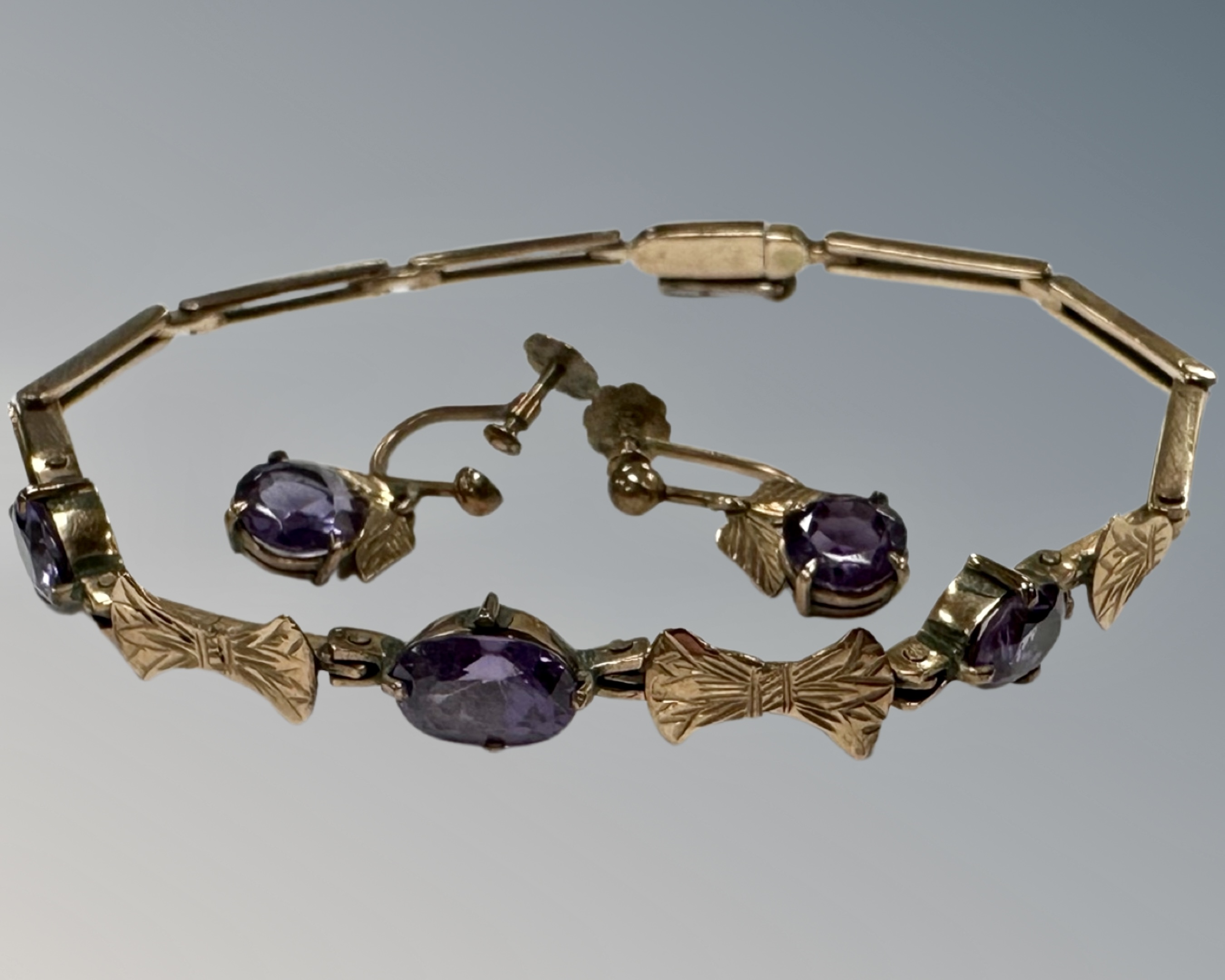 An early 20th century yellow gold bracelet set with amethyst, together with the matching earrings,