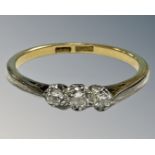 An early 20th century 18ct yellow gold and platinum set three stone diamond ring, P, 2.