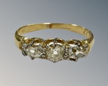 An 18ct gold three stone old-cut diamond ring, the total diamond weight estimated at 0.