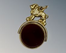 An antique yellow gold agate set fob surmounted by a lion