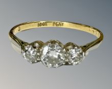 An antique 18ct gold three stone diamond ring, size P½, central stone approximately 0.4ct.