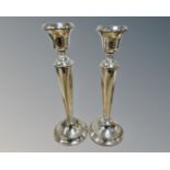 A pair of loaded silver candlesticks, marks rubbed, height 29.5cm.