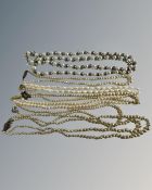 A collection of pearls and costume pearls, some with silver clasps.