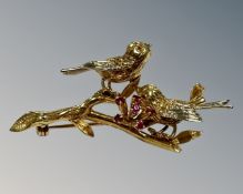 An 18ct yellow gold bar brooch modelled as two song birds on a branch,