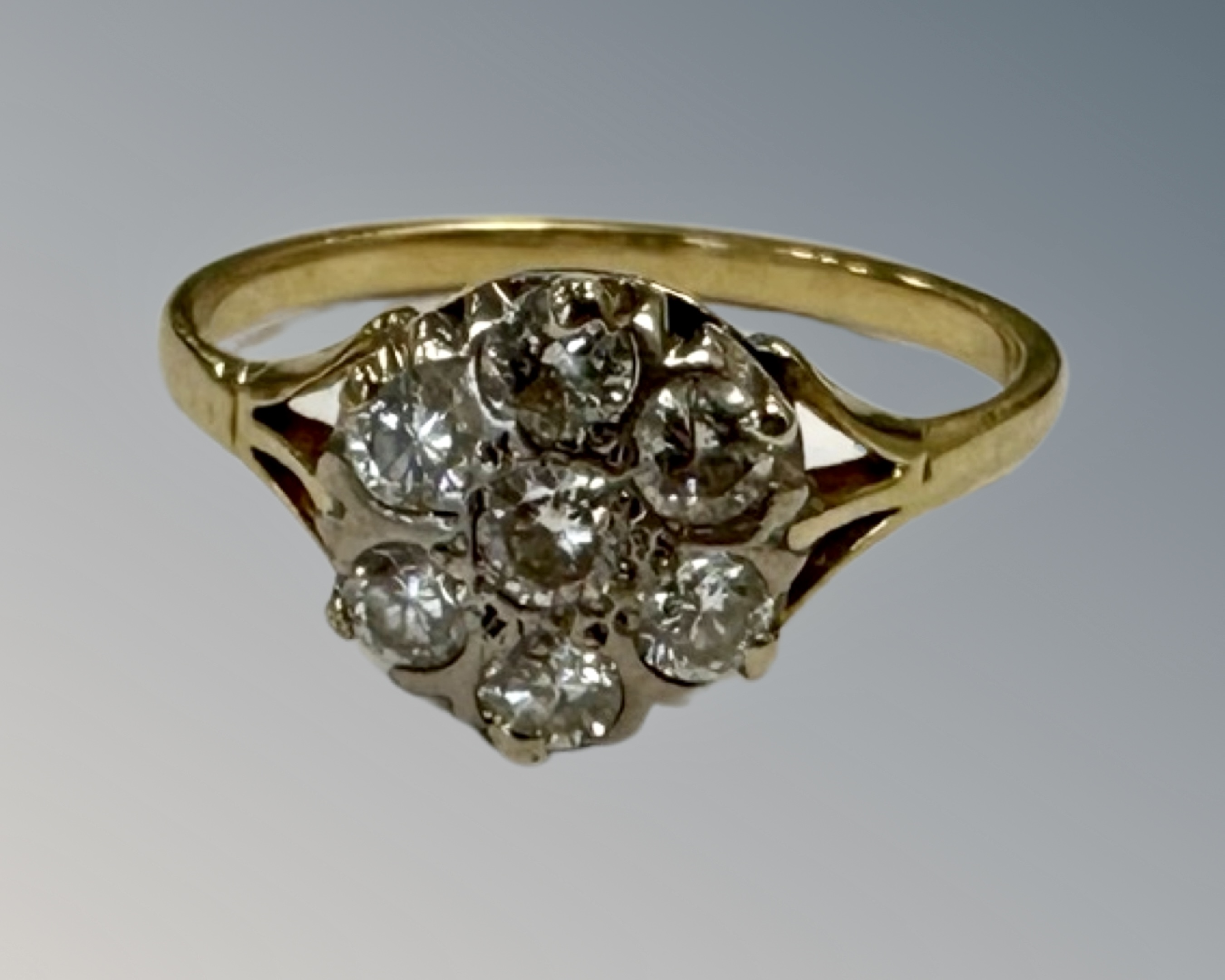A yellow gold diamond cluster ring, shank unmarked, the total diamond weight estimated at 0.