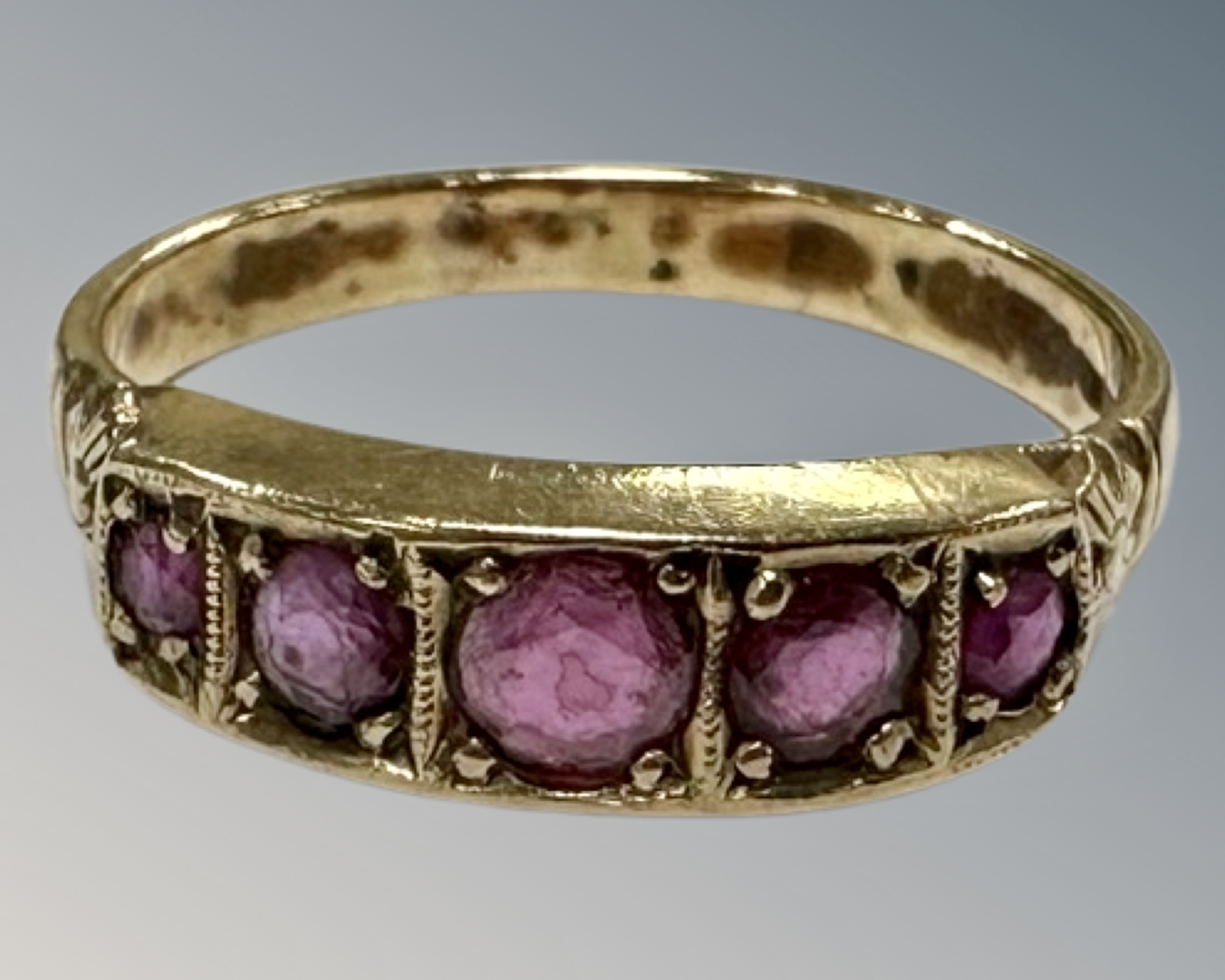 A 9ct gold five stone ruby ring, R 1/2, 3.1g.