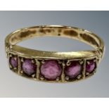 A 9ct gold five stone ruby ring, R 1/2, 3.1g.