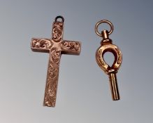 An antique yellow gold horseshoe pocket watch key together with crucifix pendant.