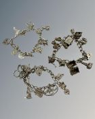 Three silver charm bracelets, 111g.