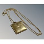 A 9ct yellow gold chain with rolled gold square locket