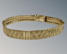 A 9ct yellow textured gold bracelet, length 18.5 cm, width 8 mm, 9.3g.