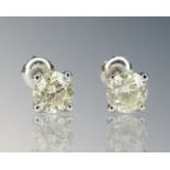 A pair of diamond stud earrings, the brilliant cut stones total 1.