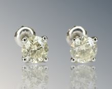 A pair of diamond stud earrings, the brilliant cut stones total 1.