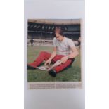 FOOTBALL, signed colour magazine photo by Johann Cruyff, showing him sitting reading on the pitch, 9